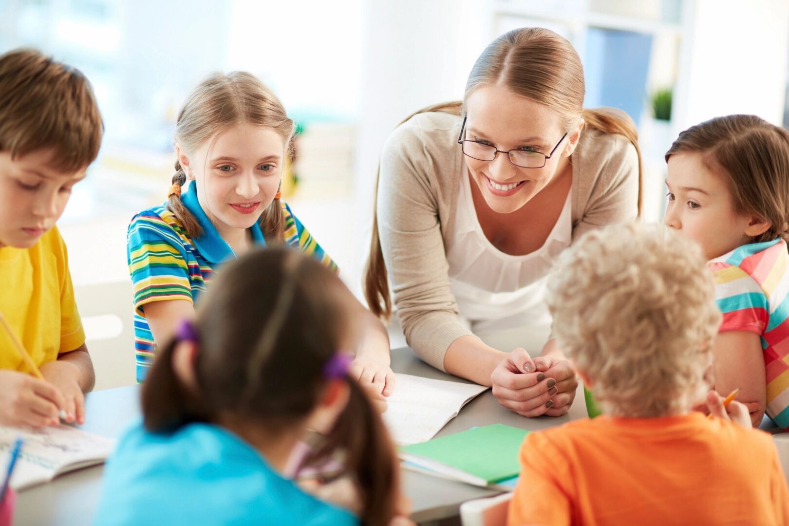 A woman and two children are sitting at a table.