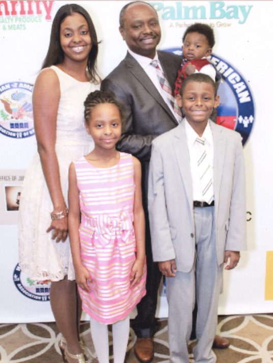 A family posing for a picture at an event.